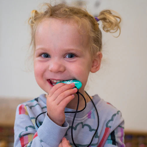 Girl chewing sensory chew pendant