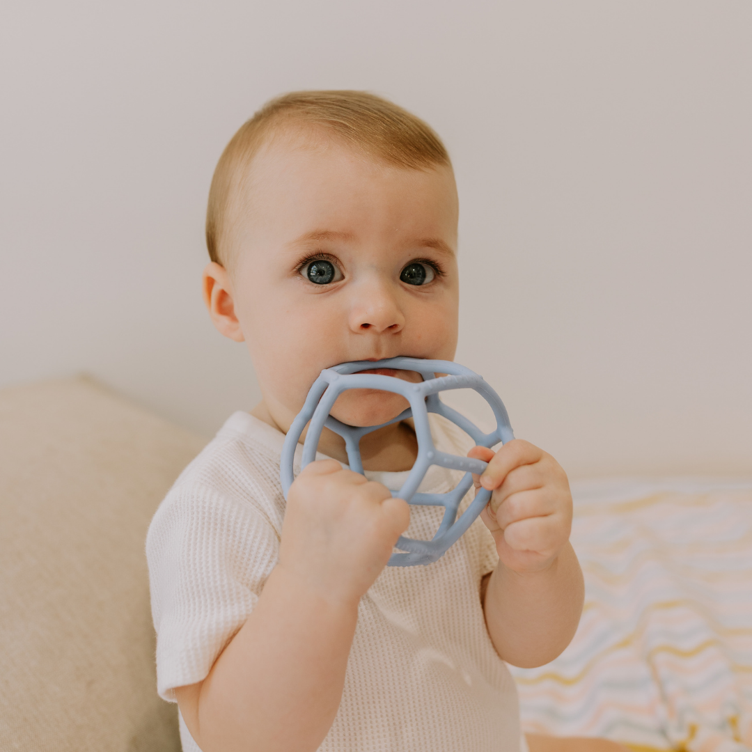 Boy chewing on silicone ball