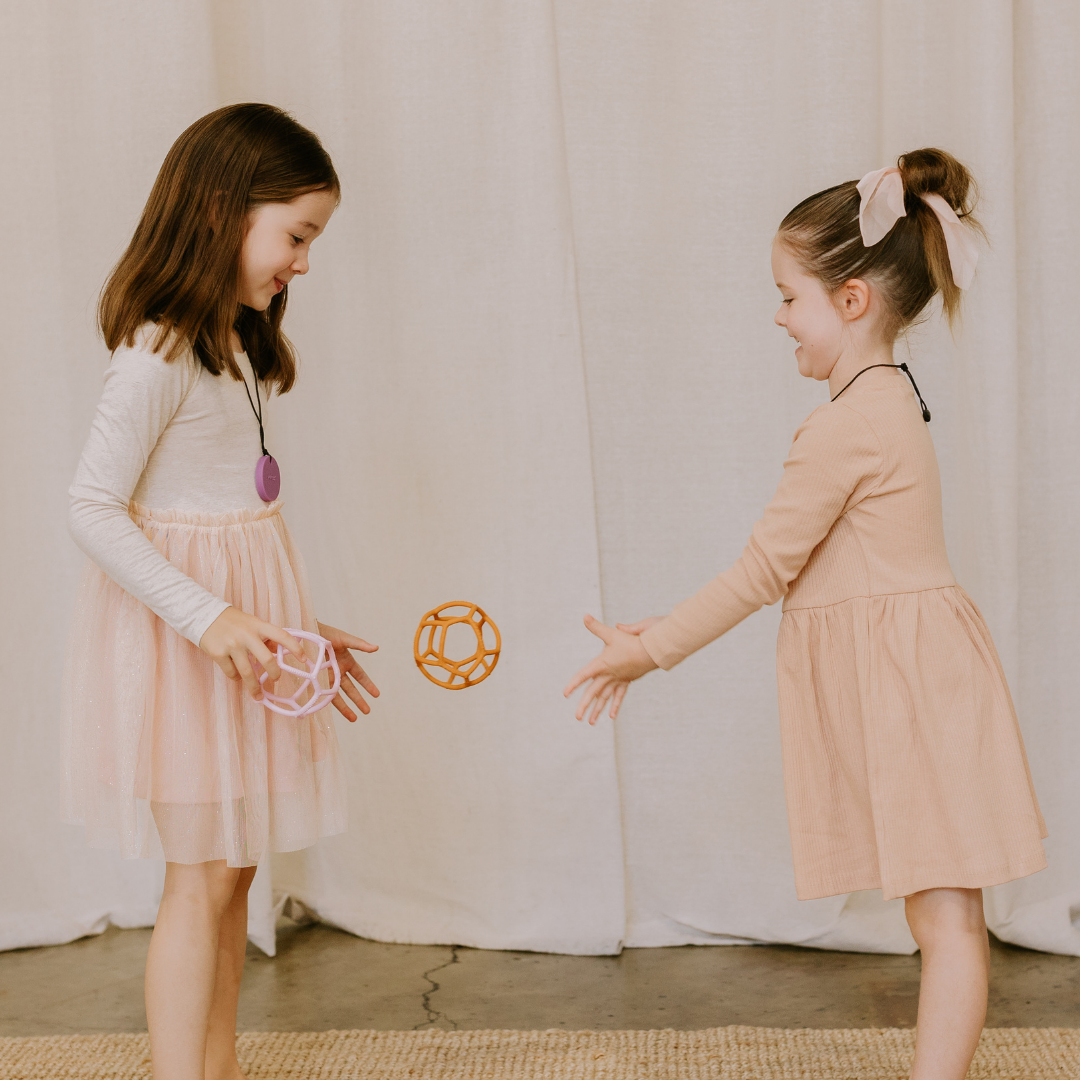 Girls throwing sensory balls to each other