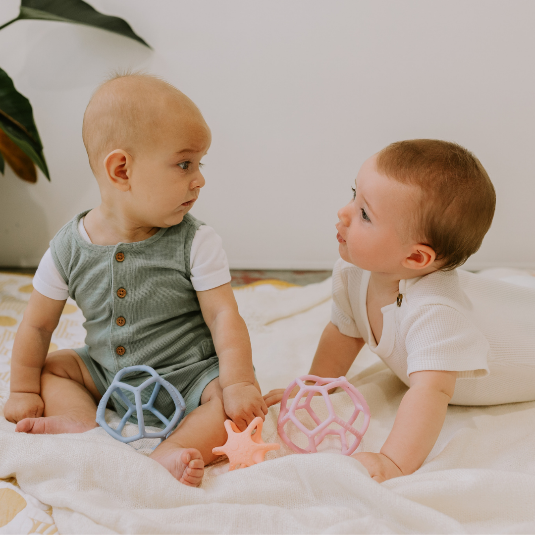 Babies playing with sensory ball 