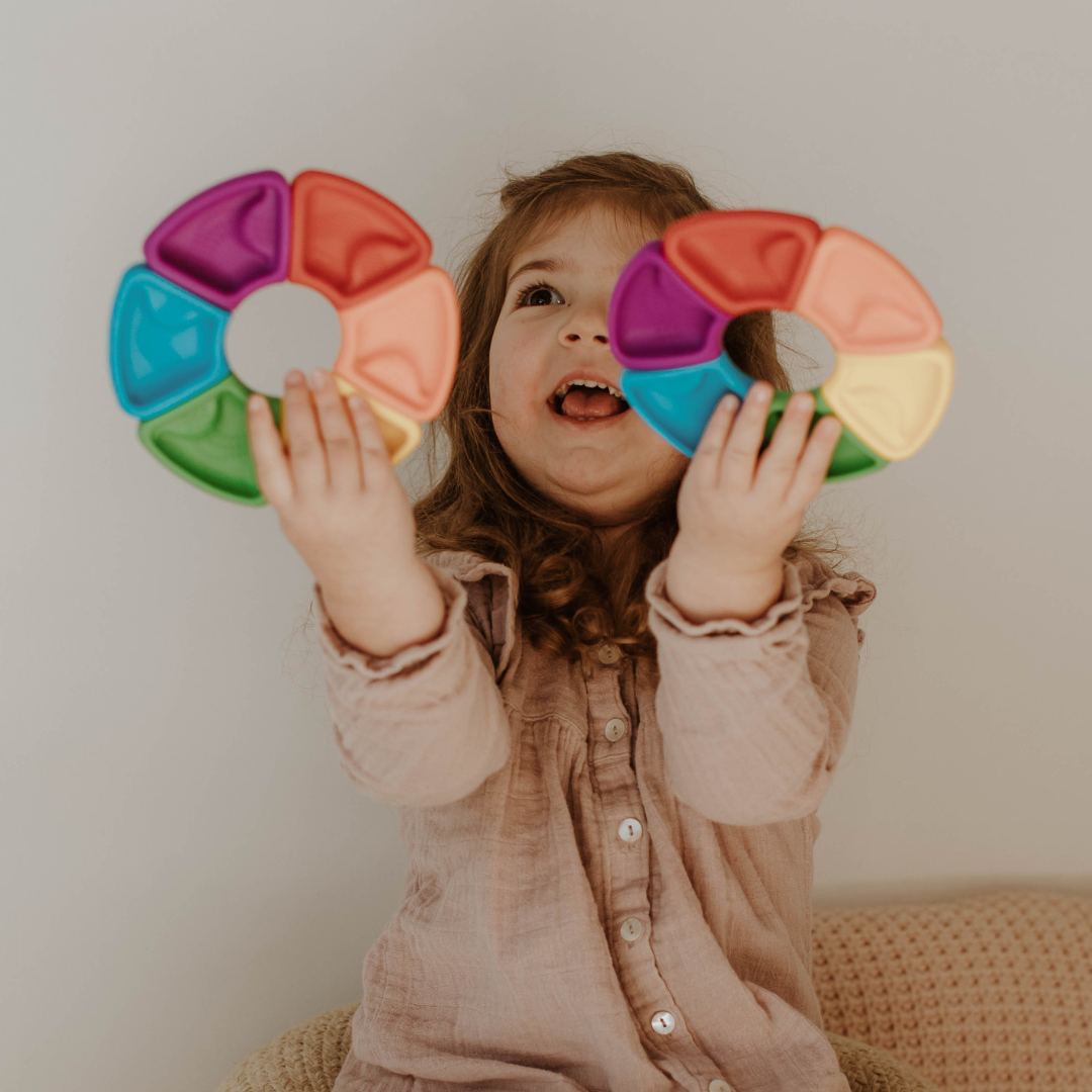 Girl holding two colour wheels