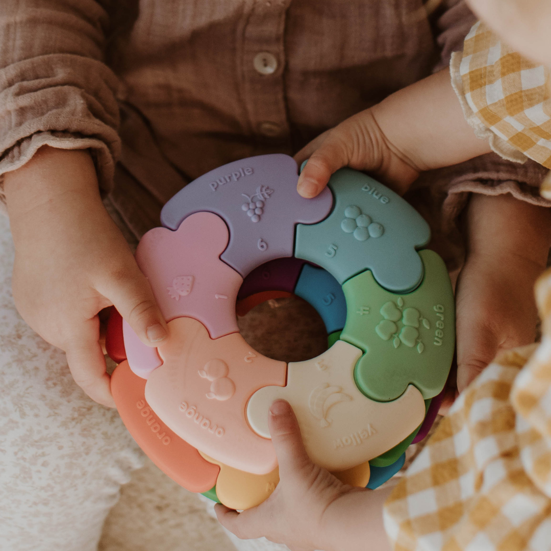 Little hands holding pastel colour wheel