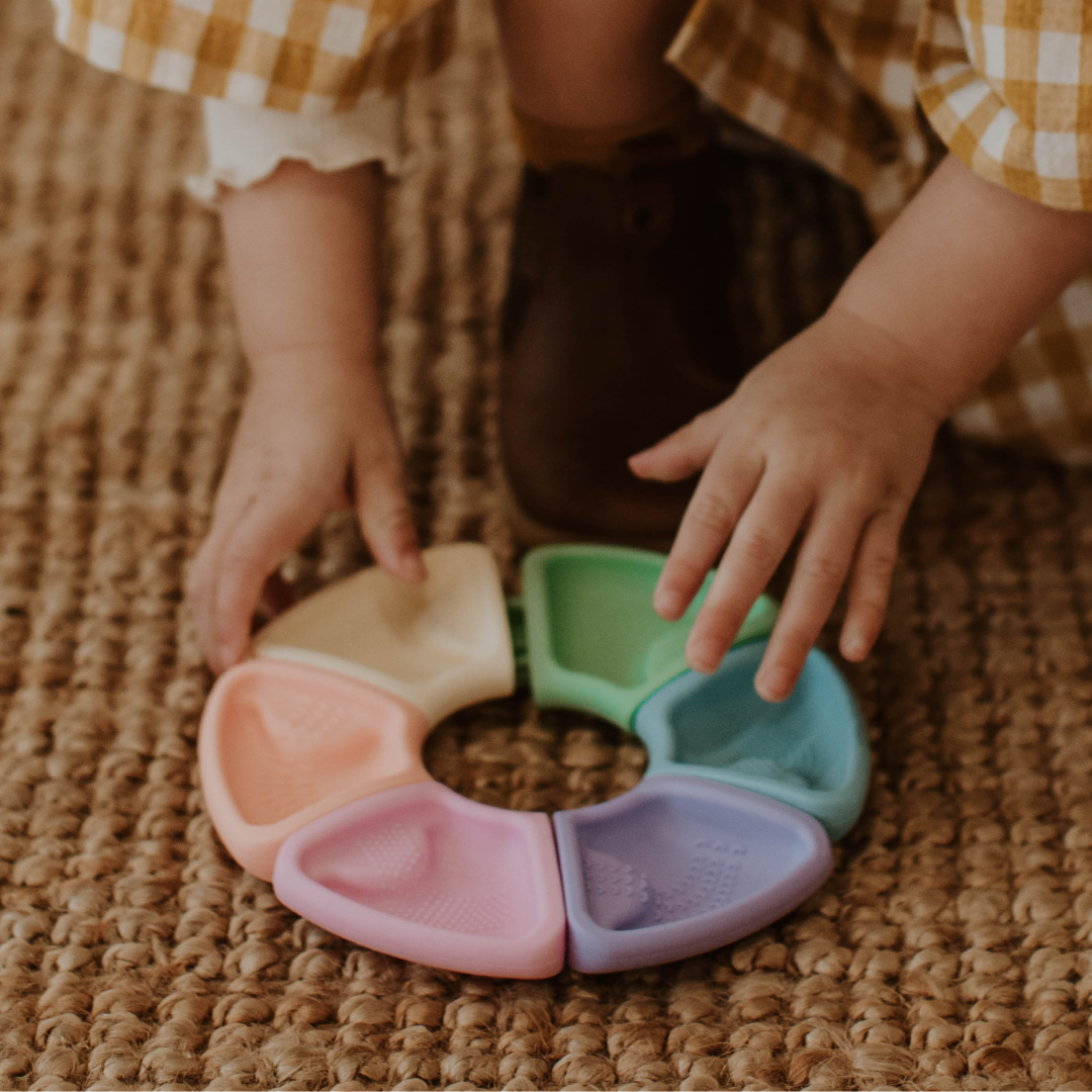 Girl picking up a colour wheel pastel