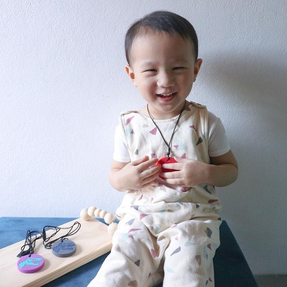 Boy wearing dino pendant