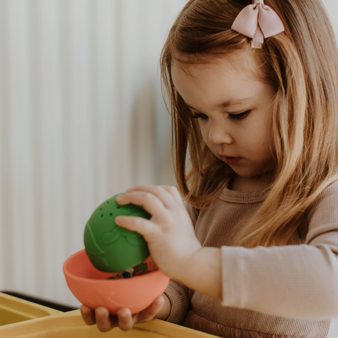 Girl holding Rainbow Stacking Cups