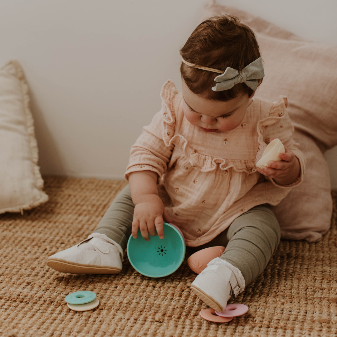 Baby Girl playing with Pastel Stacking Cups