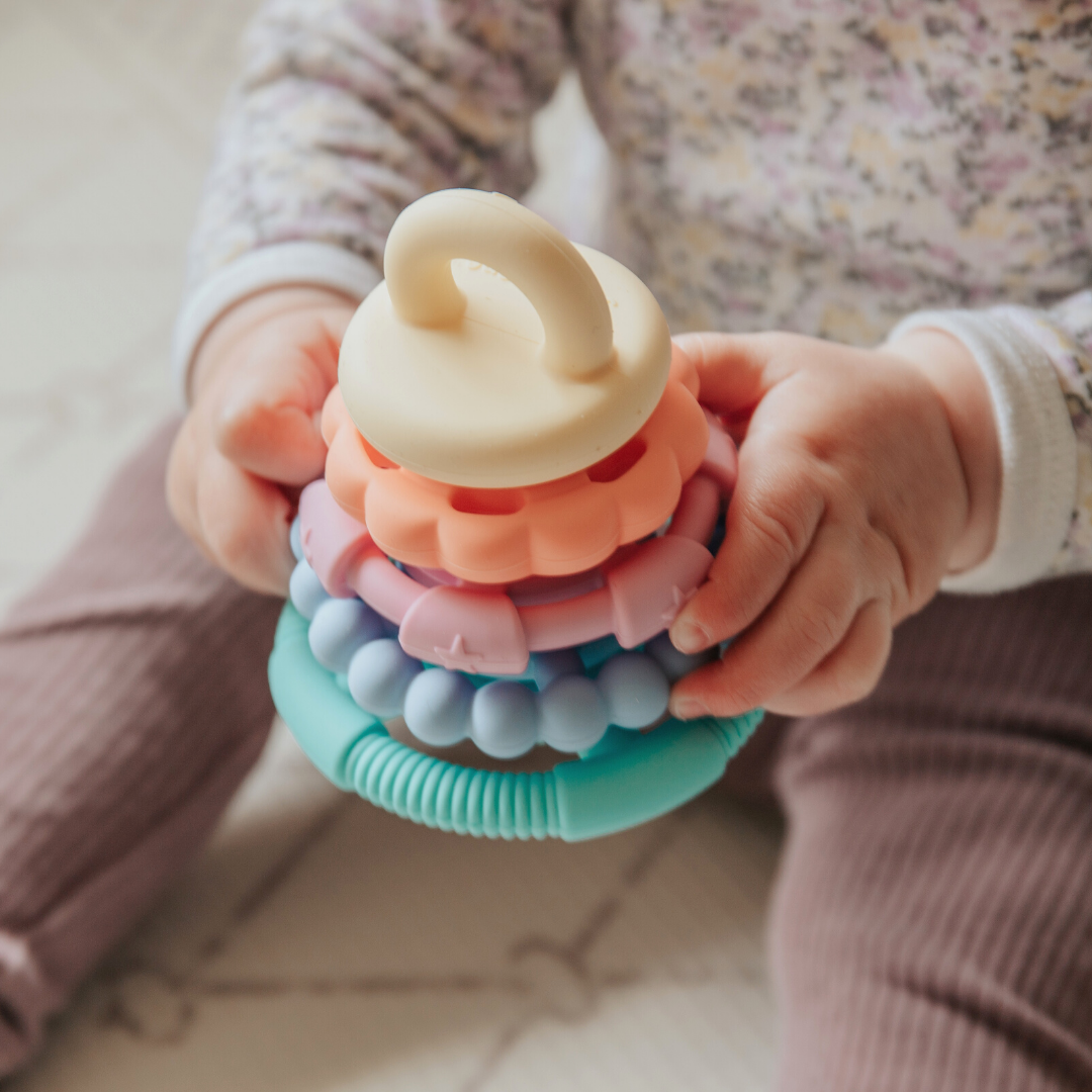 Baby holding a pastel stacker