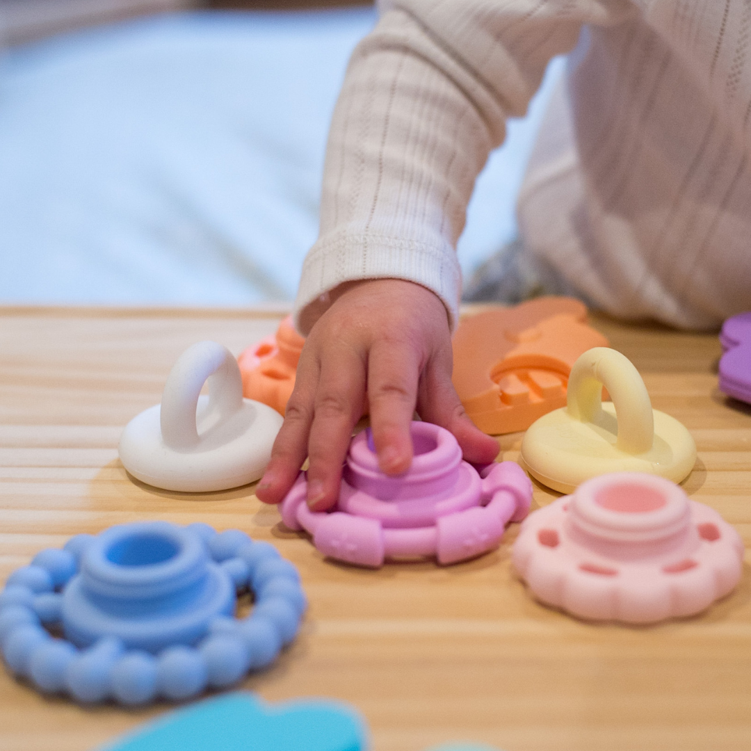 Close up of girl playing with stacker toy.