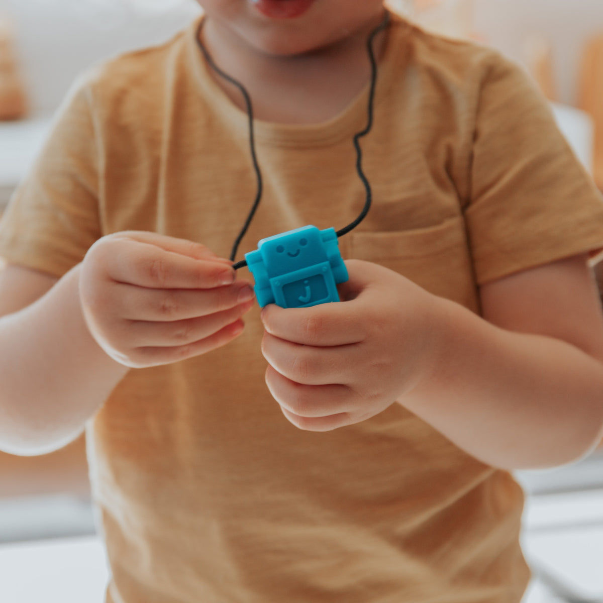 Boy holding robot pendant