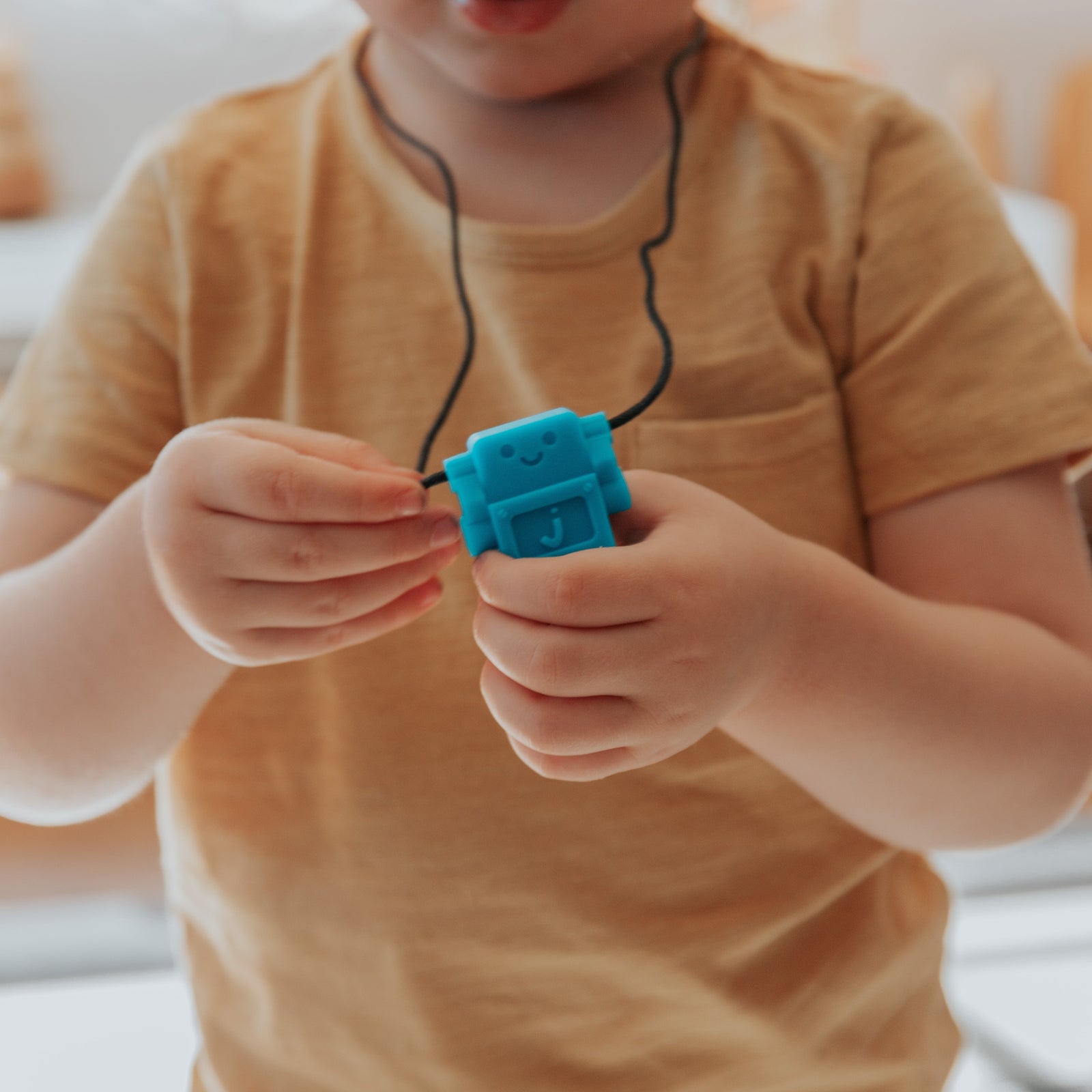 Boy holding robot pendant